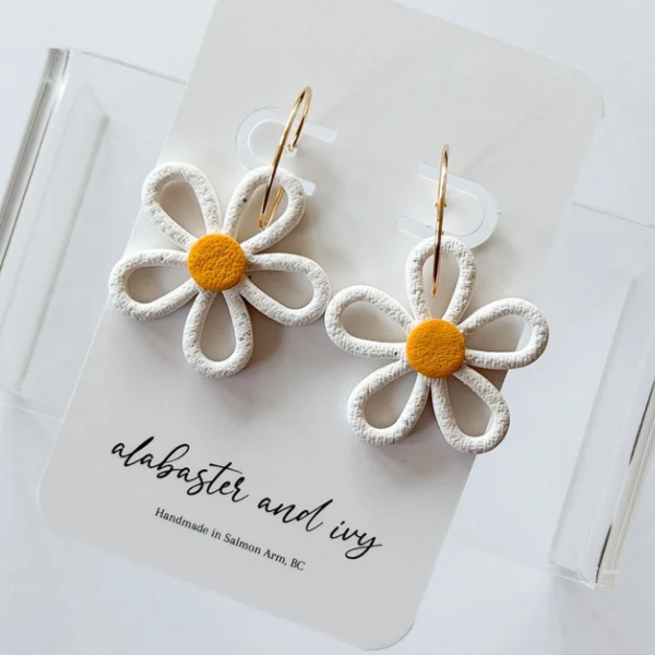 Hollow floral hoops available in either daisies or black eyed susans!
Earrings are finished with 20mm 18k gold plated hoops.